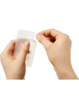 Hands applying a translucent skincare patch