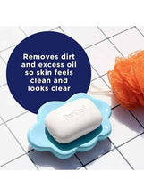 White cleansing bar on blue soap dish with lather