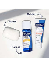 White cleansing bar beside blue skincare bottles for acne care