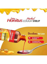 Herbal cough syrup bottle pouring syrup with directions for use text on pack