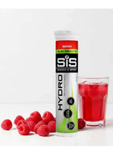 Hydro electrolyte tablets tube with red drink in glass and raspberries