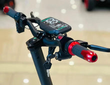 Electric scooter handlebar control panel with red grips and digital screen