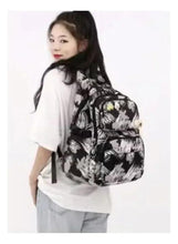 Kids rolling trolley backpack, black brushstroke print, side mesh pocket, plush toy