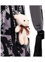 Plush bunny toy clipped to black brushstroke rolling trolley backpack