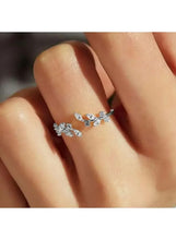 Silver-tone leaf branch ring on finger, clear rhinestone scatter