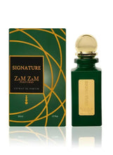 Green eau de parfum bottle with gold cap beside Signature perfume box