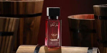 Perfume bottle with red 'Velvet Love' label and black cap