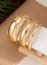 Gold tone chunky bangle bracelet set, three wide polished cuffs with shine