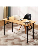 Adjustable laptop table with light wood top and black legs, closed space setup