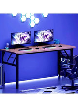Adjustable laptop table with light wood top and black legs, gaming monitors and PC