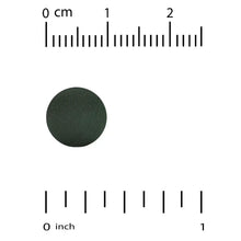 Dark green spirulina tablet with inch and cm measurement marks
