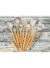 Assorted silicone kitchen utensils with wooden handles arranged in a set