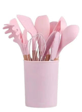 Pink silicone cooking utensil set with 12 tools in holder.