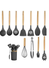 Silicone kitchen tool set with black utensil heads and wooden handles, assorted pieces
