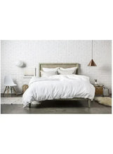 White winter duvet comforter on a bed with matching pillows