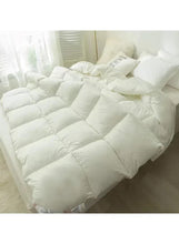 White winter duvet comforter with quilted baffles, shown on a bed