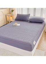 Dark grey fitted bedding topper with two matching pillowcases, arranged on bed