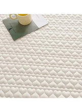 White quilted waterproof topper fabric with raised heart pattern