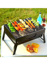 Outdoor BBQ grill with metal grate, folding legs, and skewers with vegetables and meat