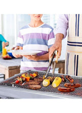 Portable charcoal BBQ grill with vegetables and skewers on stainless cooking grate