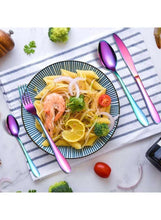 Rainbow stainless steel spoon and fork on table with plate