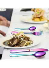 Rainbow stainless steel spoon and fork on a dinner plate