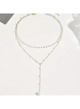 Layered pearl drop necklace with three pearl strands and a hanging pearl pendant