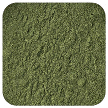 Ground wheatgrass powder, finely textured dark green surface