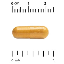 Golden gel capsule for turmeric extract supplement shown with size scale.