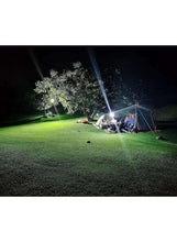 Portable LED work light casting a bright beam outdoors