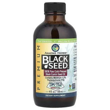 Black seed oil bottle with black cap, front label text and seal branding