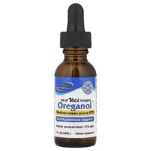 Amber glass dropper bottle with black cap, oil of wild oregano dietary supplement