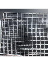 Stainless steel wire mesh grilling clip with fine grid pattern, close-up