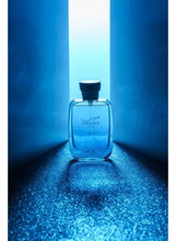 Rasasi Hawas Ice Eau de Parfum bottle, blue-tinted glass with dark ribbed cap