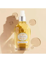 Almond skin oil bottle with silver collar and white pump, amber liquid