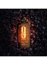 Unisex extrait de parfum bottle with gold “9 pm” “Elixir” text and black cap