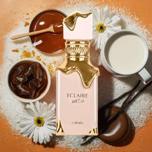 Lattafa Eclaire eau de parfum spray bottle, pink glass with gold cap and accents