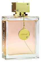 Women’s eau de parfum bottle with gold cap and round ARMAF charm