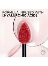 Matte liquid lipstick on plush applicator tip, red product visible