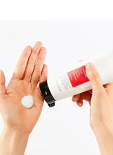 Cleanser squeeze tube with white cream dispensed onto open palm