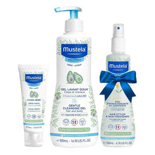 Baby skincare essentials set with three Mustela bottles, pump and spray