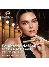 Mascara applied to model’s eyes with wand held near face