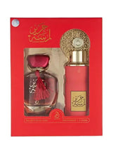 Fragrance gift set box with two red bottles, gold caps, and tassel details