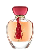 Round perfume bottle with red cap and hanging red tassel on clear glass