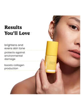 Vitamin C serum bottle held near woman's cheek and lips