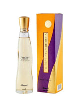 Eau de parfum bottle with gold cap and pale yellow liquid, beside the boxed set
