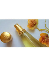 Gold glass eau de parfum bottle with gold pump sprayer