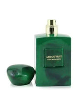 Green eau de parfum bottle with Armani/Prive label and matching dropper top