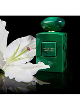 Green eau de parfum bottle with Armani/Prive label and glossy dome cap