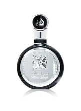 Round eau de parfum bottle with black cap and silver label face